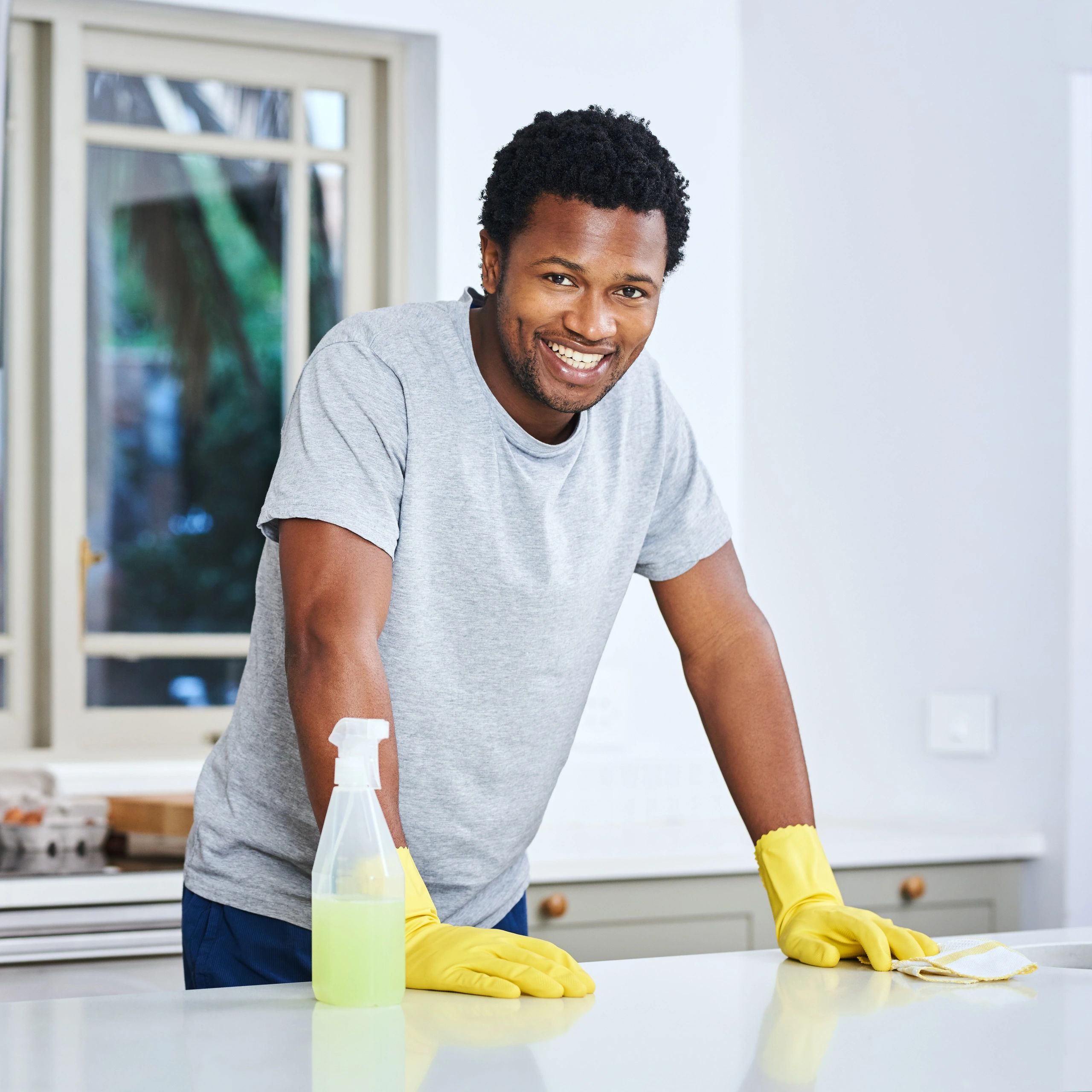 Homeowner cleaning kitchen counter