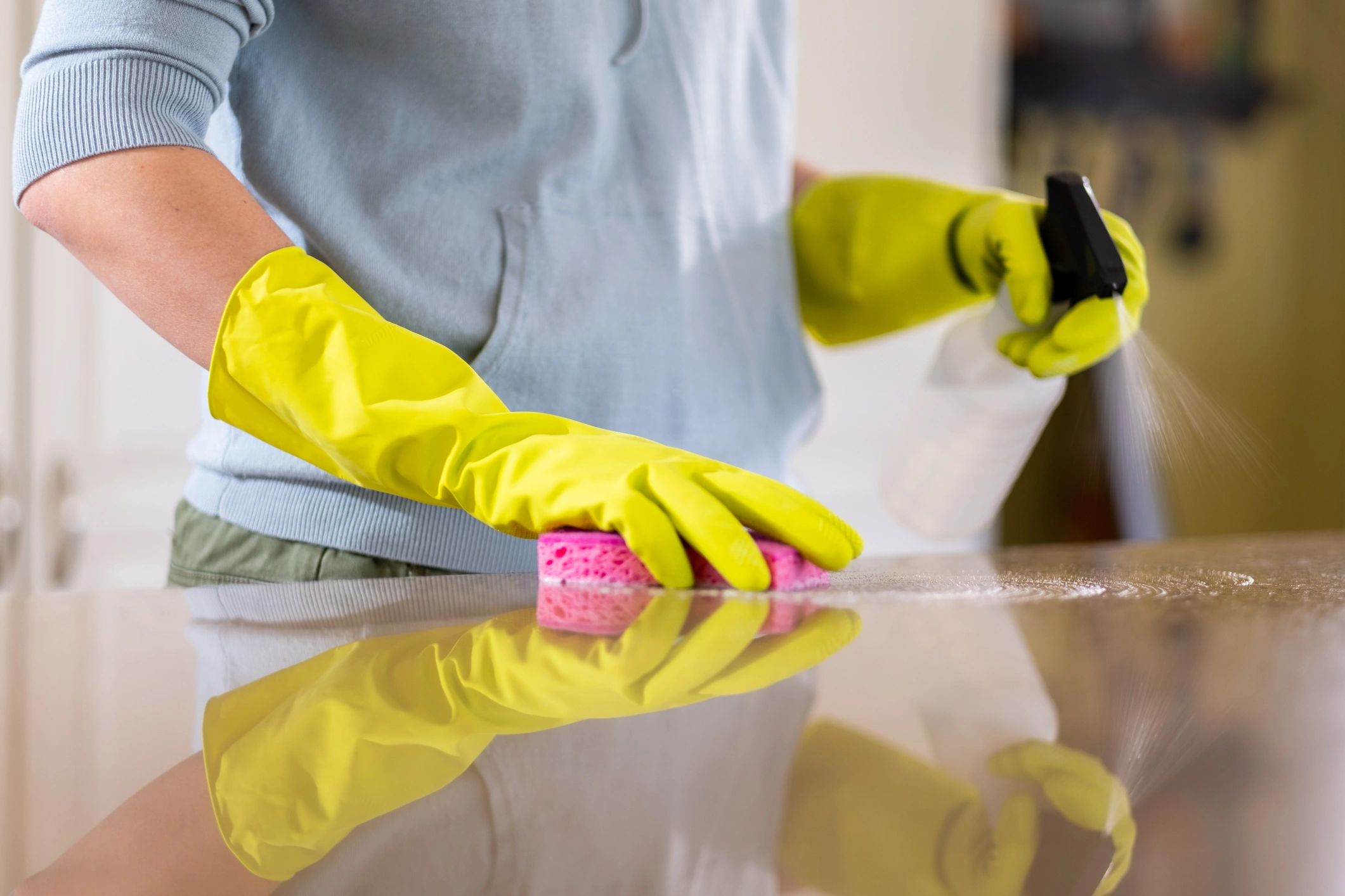 Professional cleaner sanitizing a countertop