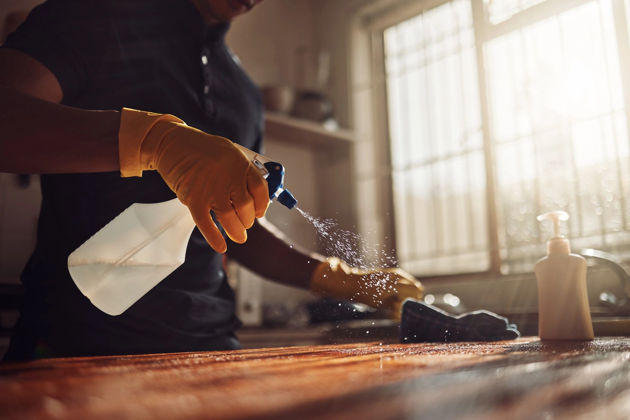 Cleaning a kitchen counter in a home