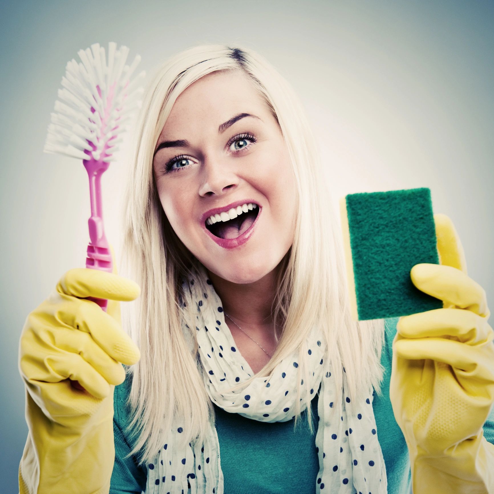 Smiling homeowner with cleaning supplies